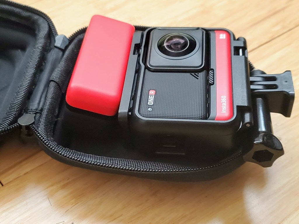 The case can fit a charger and extra battery